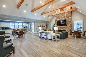 a living room with a stone fireplace and furniture at Beach Shuttle! Spacious Bishop’s Landing Retreat in Ocean View