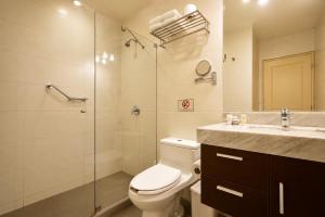 a bathroom with a toilet and a shower and a sink at Diez Canseco by 2W Aparments Service in Lima +51 photos
