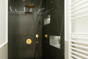 a bathroom with a shower with a black wall at Four Rooms Luxury Suite in Palermo +63 photos