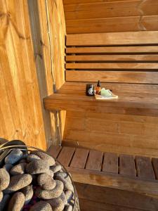 a wooden stairs with a bowl of rocks in a sauna at Dis Cottages in Grundarfjordur +40 photos