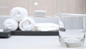 a toothbrush in a glass of water on a counter at M Star Columbus North in Worthington +25 photos