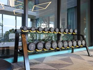 a wine rack with a bunch of wine bottles at ibis Styles Bangkok Ratchada in Bangkok