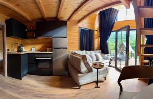 a kitchen and living room with a couch and a table at SeSam Villas in Theth