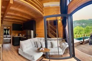 a living room with a couch and a table at SeSam Villas in Theth +99 photos
