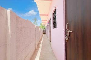 an alley with a door and a wall at SPOT ON S.S HOTEL in Lucknow