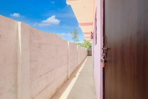 a door to a wall with a sidewalk at SPOT ON S.S HOTEL in Lucknow