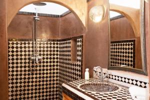 a bathroom with a sink and a mirror at Riad Lamzia in Marrakesh +57 photos