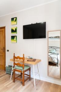 a room with a desk and a television on a wall at Aethalia Bed and Breakfast in Portoferraio