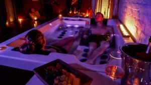 a man sitting in a bath tub with a bowl of fruit at iRelax studio - privatni wellness in Prague