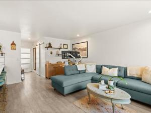 a living room with a blue couch and a table at G125 by SkyRun Aspen in Snowmass Village