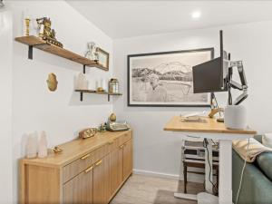 a room with a desk and a computer on a wall at G125 by SkyRun Aspen in Snowmass Village