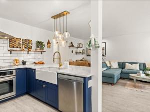 a kitchen with blue cabinets and a blue couch at G125 by SkyRun Aspen in Snowmass Village