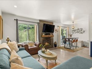 a living room with a blue couch and a table at G125 by SkyRun Aspen in Snowmass Village