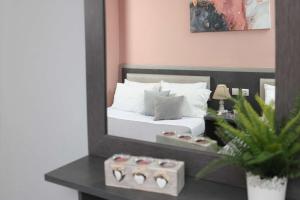 a bedroom with a bed in front of a mirror at Soluna Studios in Polychrono +41 photos