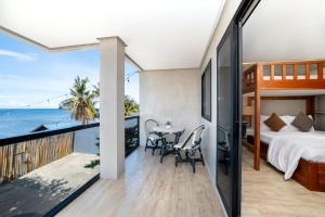 a bedroom with a bed and a view of the ocean at Bonbon Beach House in Liloan