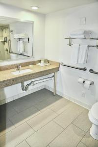 a bathroom with a toilet and a sink and a mirror at Alhambra Hotel in Alhambra +66 photos