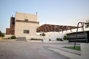 a building with a basketball hoop in front of it at La mira chalet in Madaba
