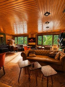a living room with a couch and a table at Ayder Doga Resort in Ayder Yaylasi