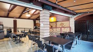 a group of tables and chairs in a restaurant at Alhambra Hotel in Alhambra