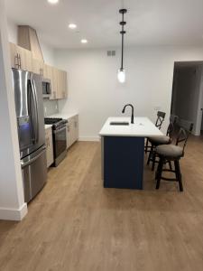 a kitchen with a sink and a counter with chairs at 2 Bedroom Apartment in Seaside Heights +2 photos