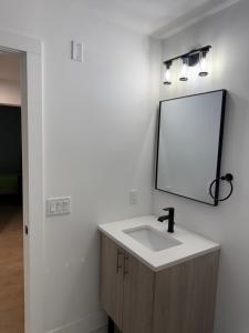 a bathroom with a sink and a mirror on the wall at 2 Bedroom Apartment in Seaside Heights