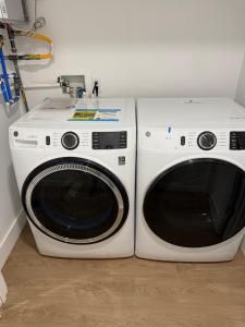 two white washing machines sitting next to each other at 2 Bedroom Apartment in Seaside Heights