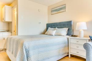 a bedroom with a bed with a blue headboard at Old Orchard Beach Condo: Steps From the Beach! in Old Orchard Beach