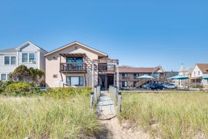 a house on the beach with a fence at Old Orchard Beach Condo: Steps From the Beach! in Old Orchard Beach +18 photos