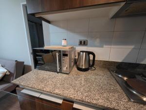 a kitchen counter with a microwave on a counter top at Dpto 2D2B Barlovento Brisas del Sol in Talcahuano