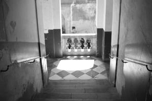 a hallway with a window and a checkered floor at B&B Gallidoro in Palermo