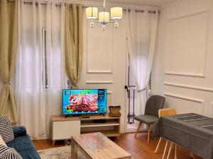a living room with a television on a table at Pretty central flat in Ceuta