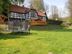 two people playing on a trampoline in front of a house at Gaststätte & Pension Lochbauer in Plauen