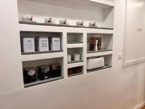 a room with shelves on the wall with medicines at Pretty central flat in Ceuta +1 photo