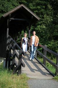 a man and a woman walking on a bridge at Gaststätte & Pension Lochbauer in Plauen +4 photos