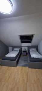 two beds in a room with a ceiling at Apartment in Bergheim