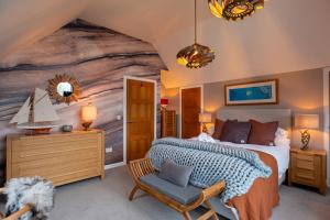 a bedroom with a large bed and a sailboat mural at The Wolfie Lodge in Carbost