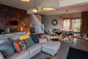 a living room with a couch and a table at The Wolfie Lodge in Carbost