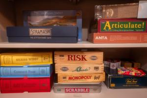 a shelf filled with lots of pizza boxes at The Wolfie Lodge in Carbost