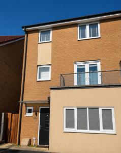 a brick building with a balcony on top of it at MpaNjus - Double Rooms, Shared House in Bristol