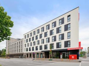 a large white building on a city street at ibis Regensburg Zentrum in Regensburg
