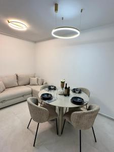 a living room with a table and chairs and a couch at APP Steps to the Sea 2026 in Funtana +10 photos