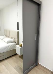 a bedroom with a door leading to a bed at APP Steps to the Sea 2026 in Funtana