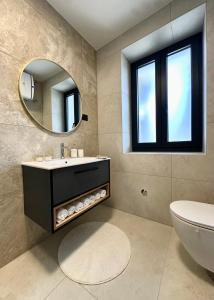 a bathroom with a sink and a mirror at APP Steps to the Sea 2026 in Funtana