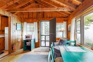 a living room with a couch and a table at Water Views & Deck! Peaceful Northport Escape in Northport +20 photos