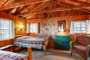 a bedroom with two beds in a wooden cabin at Water Views & Deck! Peaceful Northport Escape in Northport