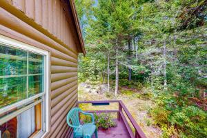 a porch with a blue chair and a window at Water Views & Deck! Peaceful Northport Escape in Northport