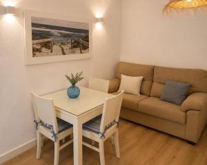 a living room with a table and a couch at DUNA - Escapada romántica en Punta Paloma in Tarifa +1 photo