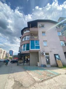 a tall building on the corner of a street at Otoka Hostel in Sarajevo