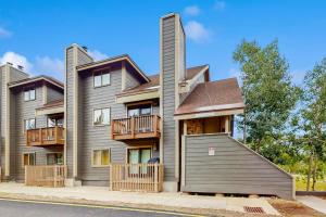 a large house with a balcony on a street at Elevation Hideaway in Durango Mountain Resort