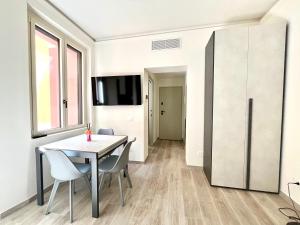 a dining room with a table and chairs at Garibaldi Living - Centro Storico Parma in Parma